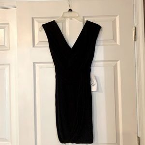 Short black dress with plunging neckline .
